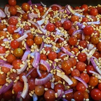 cherry tomatoes, red onion and pine nuts